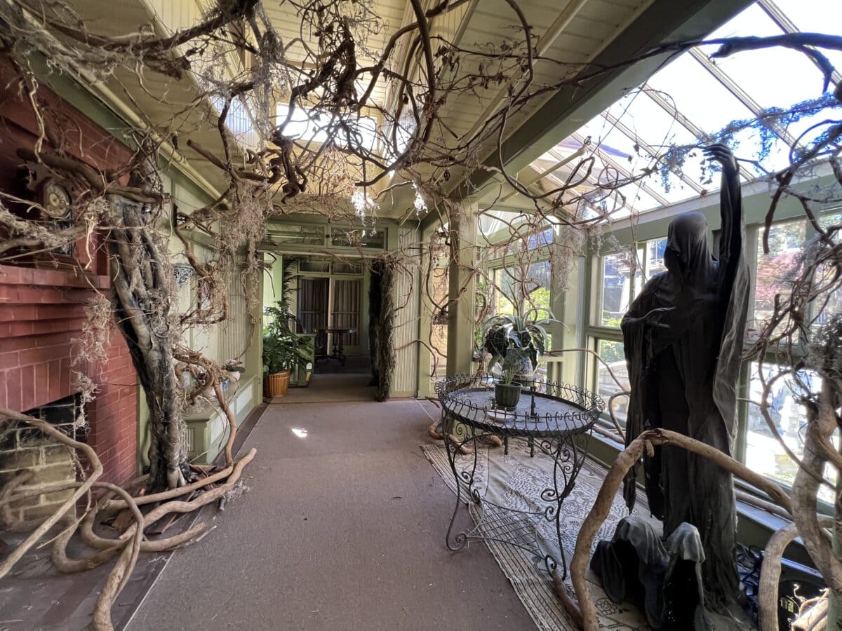 Inside Winchester Mansion, in creepy solarium with vines and statue