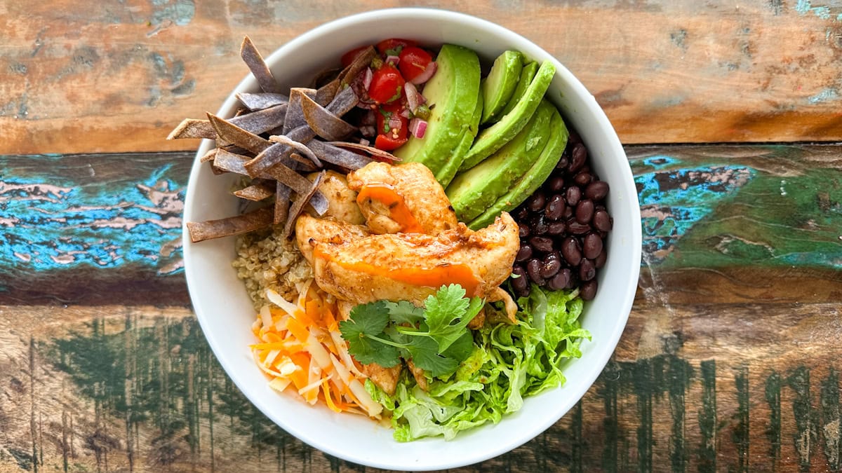 bol repas avec lanières de poulet, avocat, fromage, légumes, tortilla