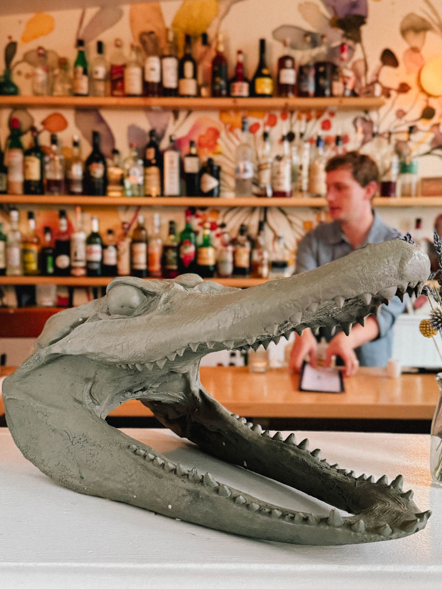 vue du bar du restaurant Beach Pea derrière une tête de crocodile statut