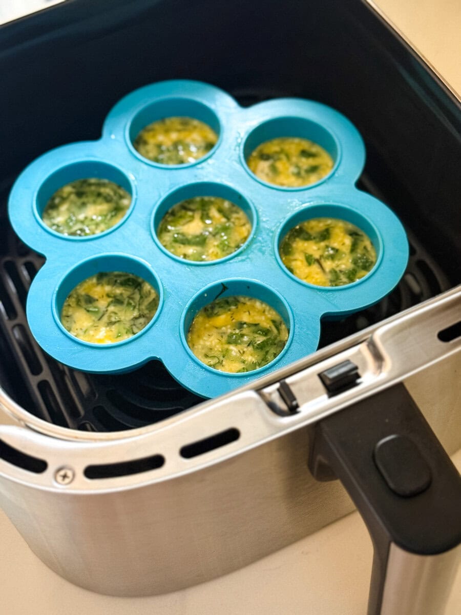 bouchées aux oeufs dans moule en silicone bleu dans panier du air fryer