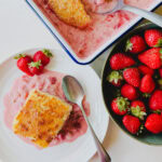 pouding fraise rhubarbe avec gros bol de fraises sur comptoir blanc